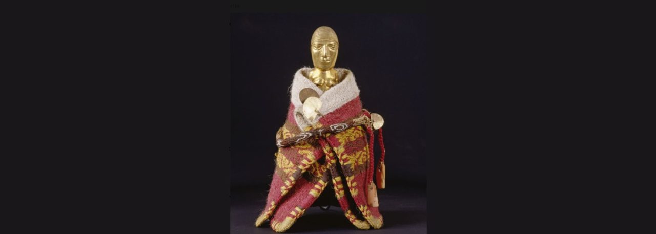 Golden figure wrapped in colorful fabric, likely symbolizes cultural or historical significance.